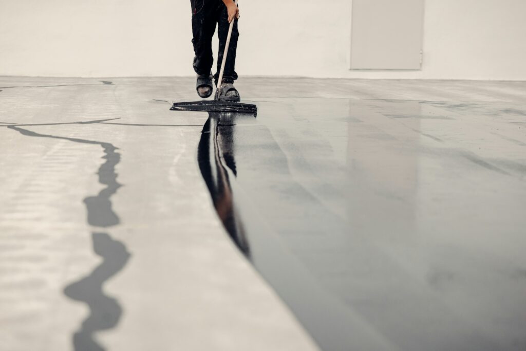 Application of epoxy solid floor coating by Jak’s Colors in a Greenwich commercial space.