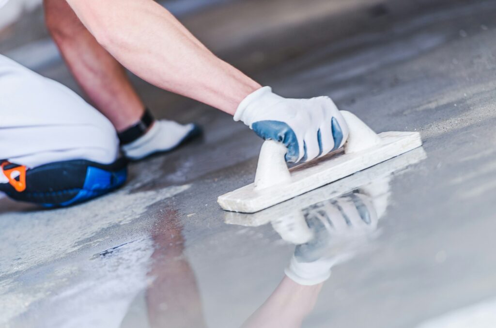 Before and after transformation of a concrete floor in Greenwich using microtopping.