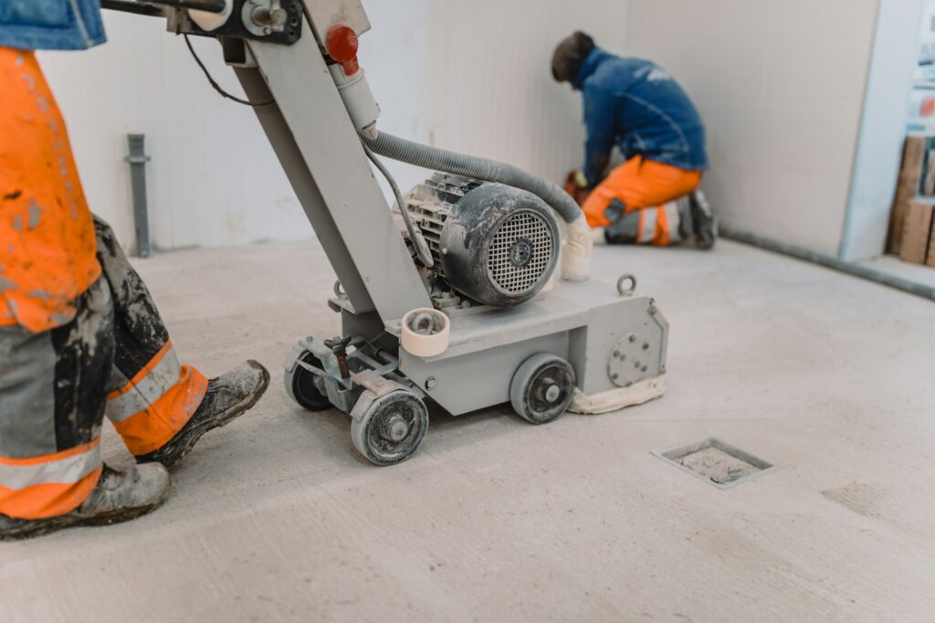 Team polishing a commercial concrete floor in Greenwich with specialized equipment.