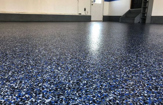 Close-up of textured epoxy flakes system flooring in Stamford with a durable, decorative finish.